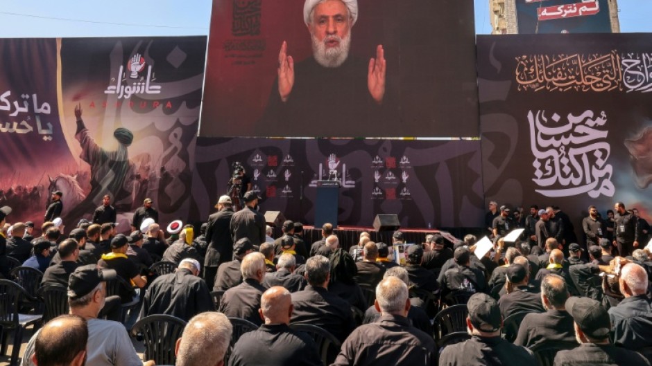 Lebanese Shiite Hezbollah supporters listen to a televised speech by the movemen't leader Naim Qassem during a ceremony during the peak of Ashura