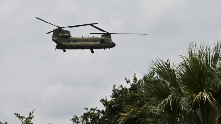 A helicopter flies overhead looking for missing people in Kerrville, Texas