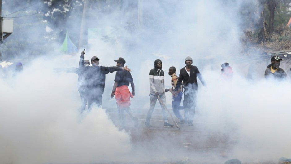 Protesters engulfed in tear gas fired by the police