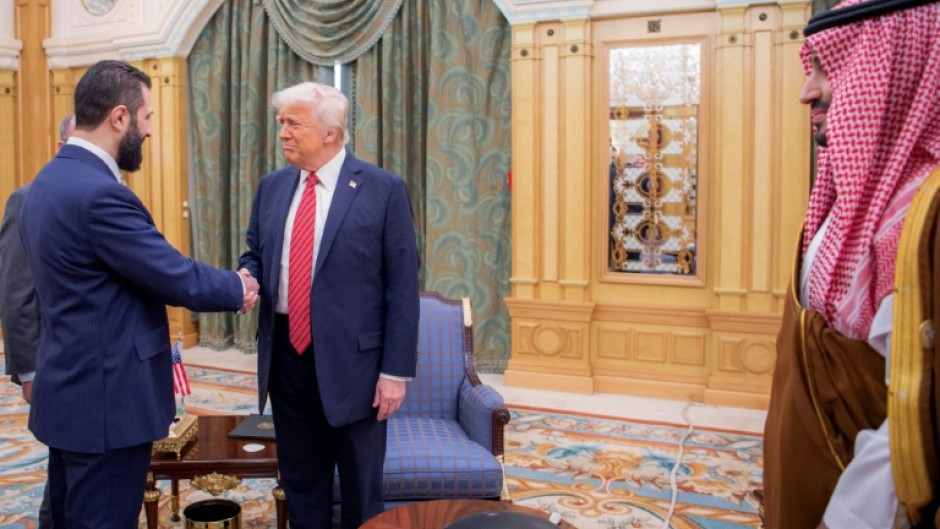 US President Donald Trump (C) met with Syria's interim president Ahmed al-Sharaa (L), a former Islamist guerilla commander, during a visit to Riyadh on May 14