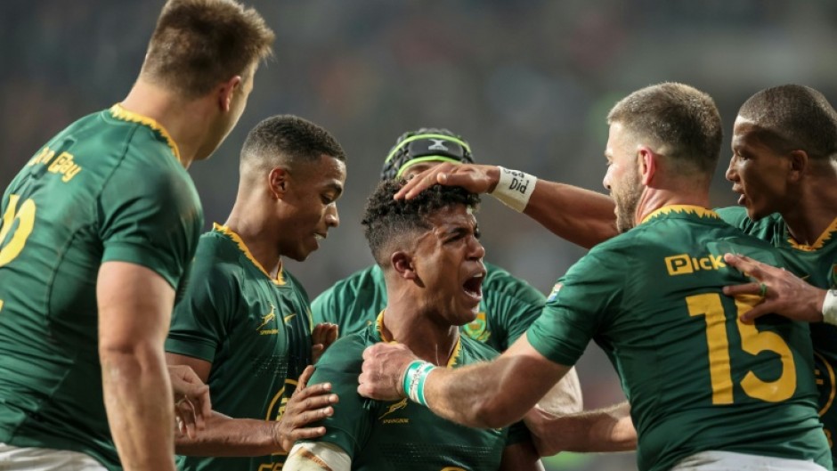 South Africa centre Canan Moodie (C) is congratulated after scoring a try against Italy.
