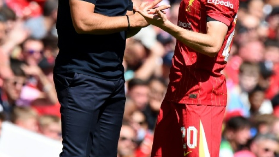 Arne Slot (L) talks to Diogo Jota during Liverpool's pre-season friendly against Sevilla in August 2024