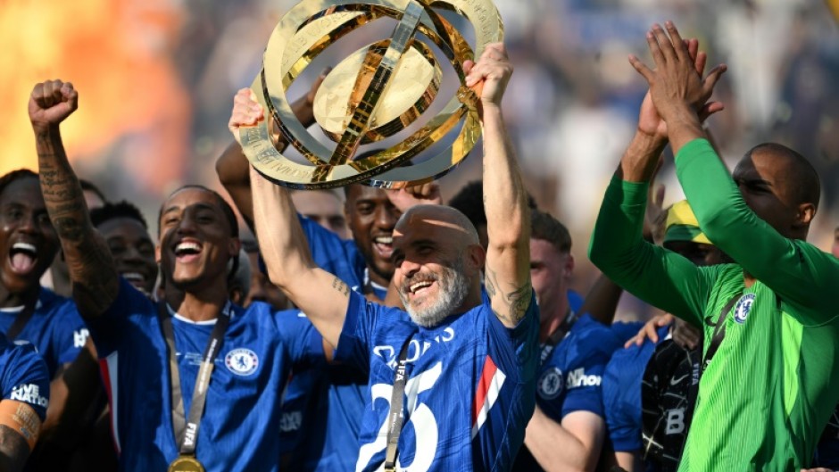 Chelsea coach Enzo Maresca lifts the trophy after his team beat Paris Saint-Germain in Sunday's Club World Cup final