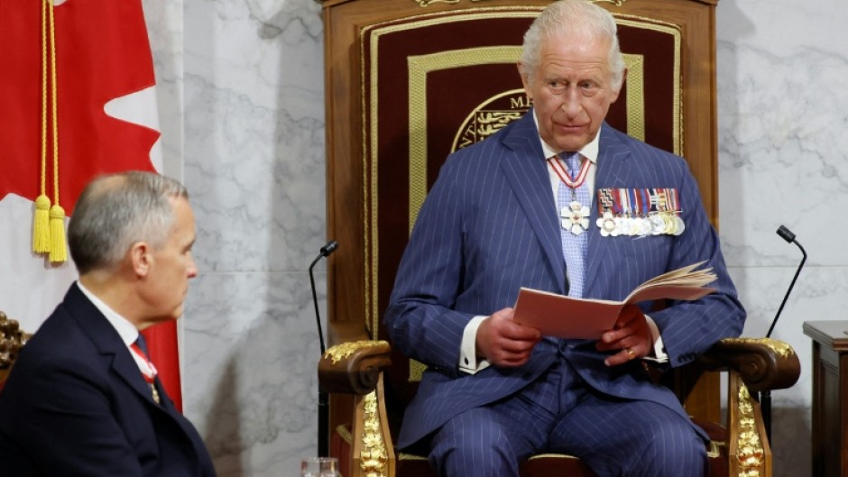 Head of State King Charles III delivers the speech from the throne next to Canada's Prime Minister Mark Carney during the opening of the Canadian parliament in May