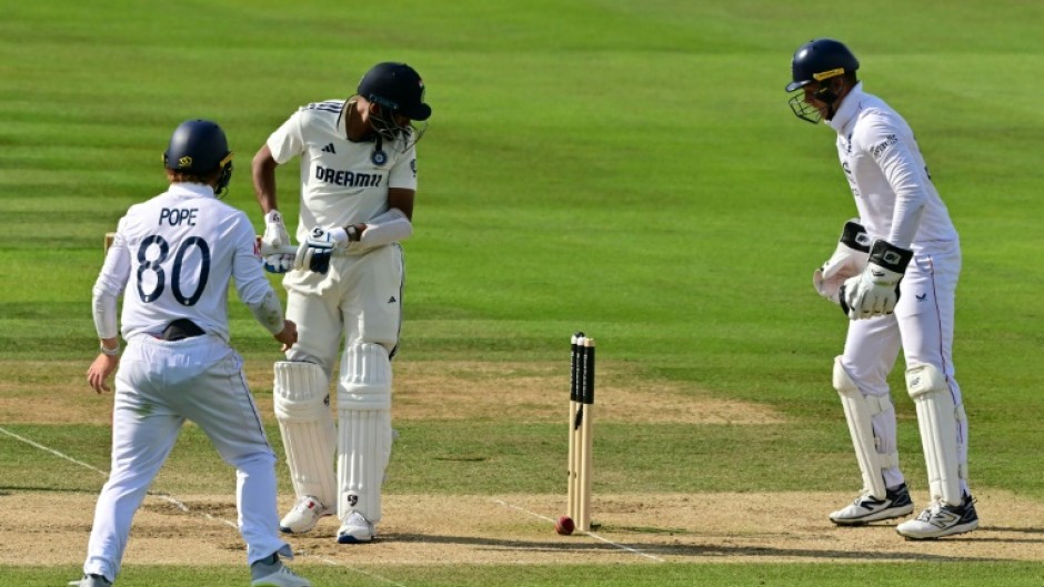 India's Mohammed Siraj (2L) can only watch as a ball from Shoaib Bashir spins back onto his stumps as Ollie Pope (L) and Jamie Smith (R) look on, as England win the third Test at Lord's by 22 runs