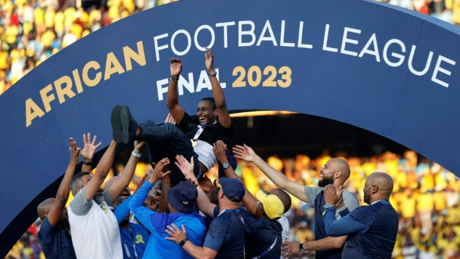 South African coach Rulani Mokwena (C) is lifted by Mamelodi Sundowns staff after winning the inaugural African Football League.