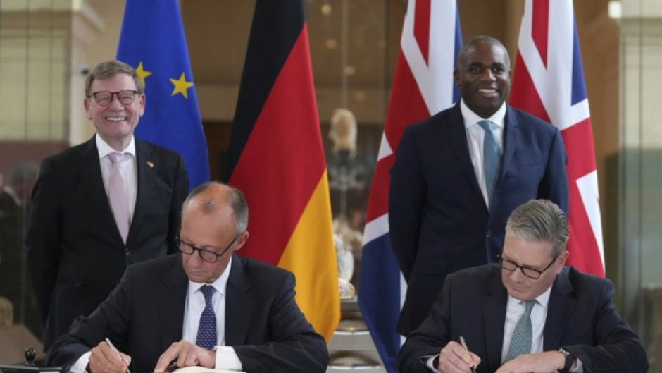Britain's Prime Minister Keir Starmer and Germany's Chancellor Friedrich Merz sign a bilateral cooperation treaty in London with Germany's Foreign Minister Johann Wadephul and Britain's Foreign Secretary David Lammy, behind, looking on