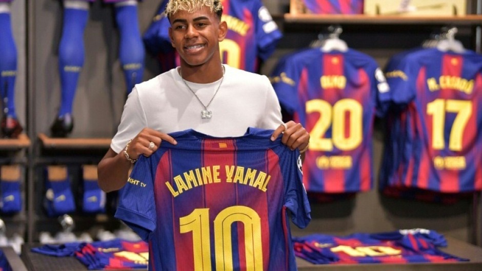 Lamine Yamal with the club's number 10 shirt previously worn by legend Lionel Messi