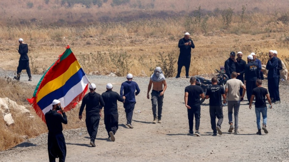 Members of the Druze community from both sides cross the demilitarised zone between Syria and the Israeli-annexed Golan Heights
