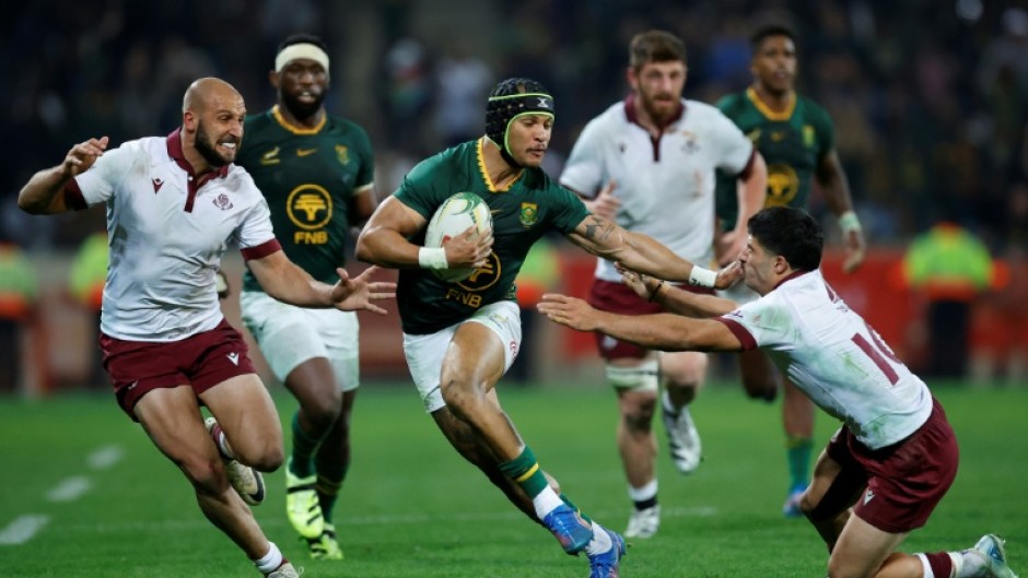 South Africa winger Edwill van der Merwe (C) bursts past Georgia defenders in Mbombela.
