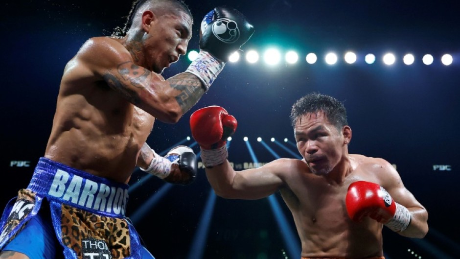 Manny Pacquiao (right) connects with Mario Barrios during their WBC welterweight title fight that ended in a majority draw