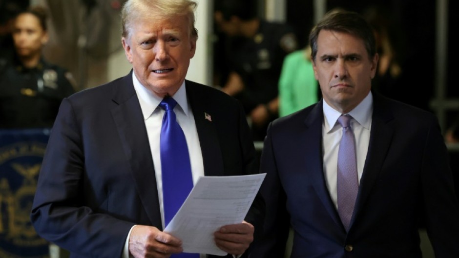 President Donald Trump, flanked by his lawyer Todd Blanche, speaks to reporters at his hush money trial in New York in May 2024