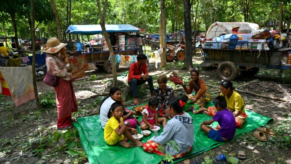 People who fled their homes near the Cambodia-Thailand border rest on the grounds of a pagoda in Oddar Meanchey province
