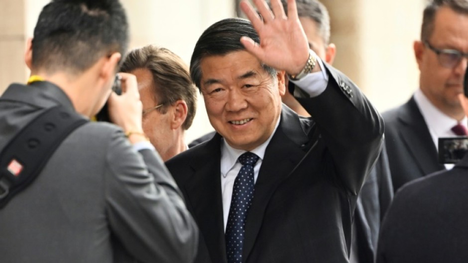China's Vice Premier He Lifeng (C) waved as he arrived for talks with the US officials in Sweden