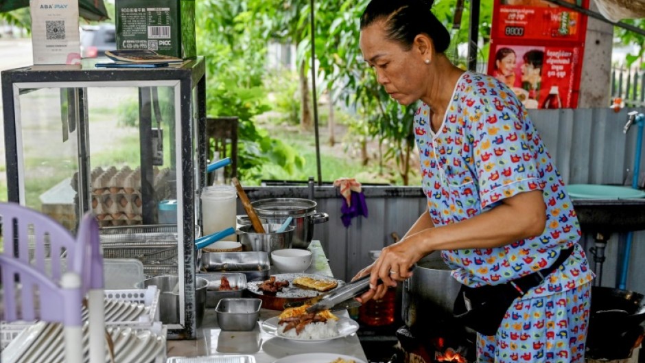 Soeung Chhivling prepares food for customers at her restaurant in Samraong, around 20 kilometres from the border conflict zone