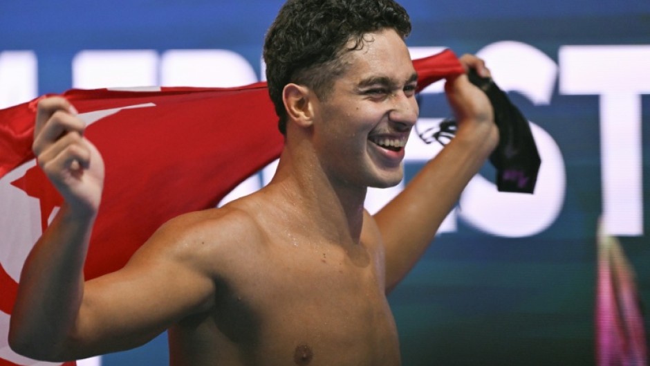 Tunisia's Ahmed Jaouadi grabbed gold in the 1,500m freestyle ahead of Germany's Sven Schwarz and Olympic champion Bobby Finke