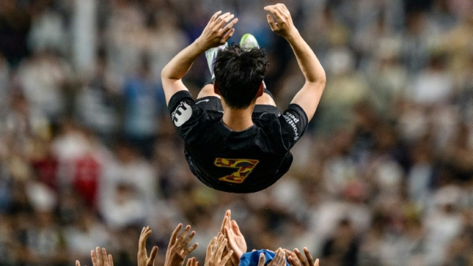 Teammates throw Tottenham Hotspur's captain Son Heung-min up in the air