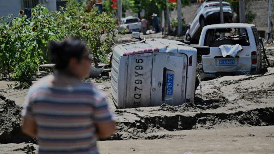 Damaged cars seen at the end of July in Huairou district, on the outskirts of Beijing after heavy rains caused widespread flooding