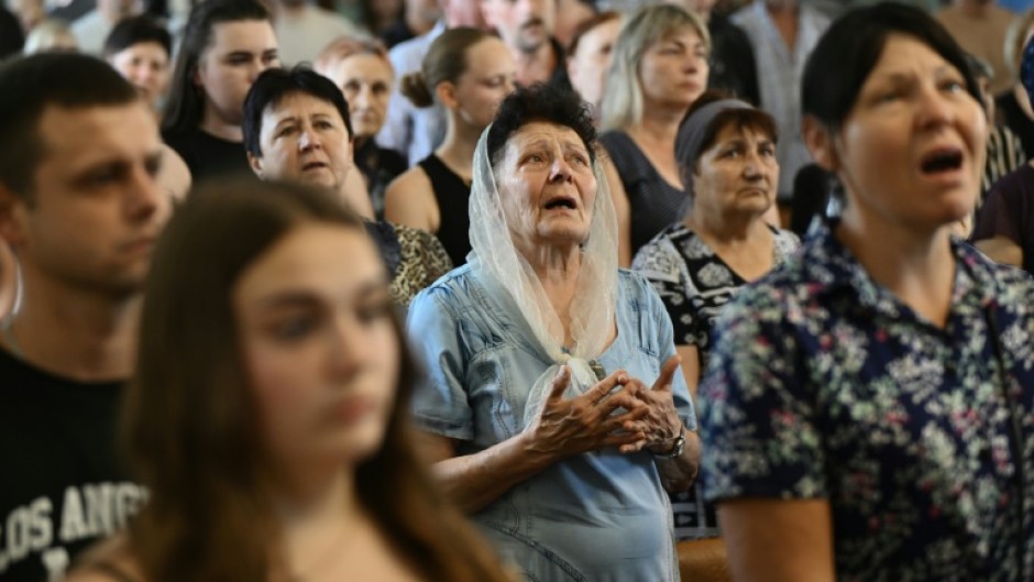A farewell ceremony for Mykyta and Sofia Lamekhov and their son Lev at a church in Sloviansk