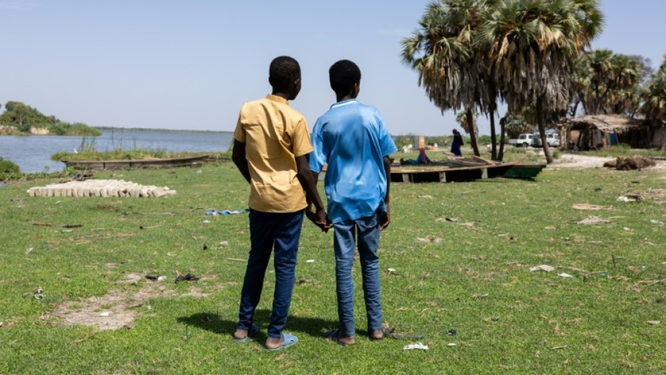 Two friends walk at the Ngorerom camp for internal displaced persons in Lake Chad province, afflicted by jihadist violence