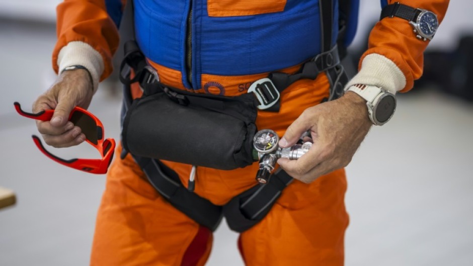 Raphael Domjan holds his oxygen cylinder as the Swiss adventurer prepares to get into the SolarStratos plane