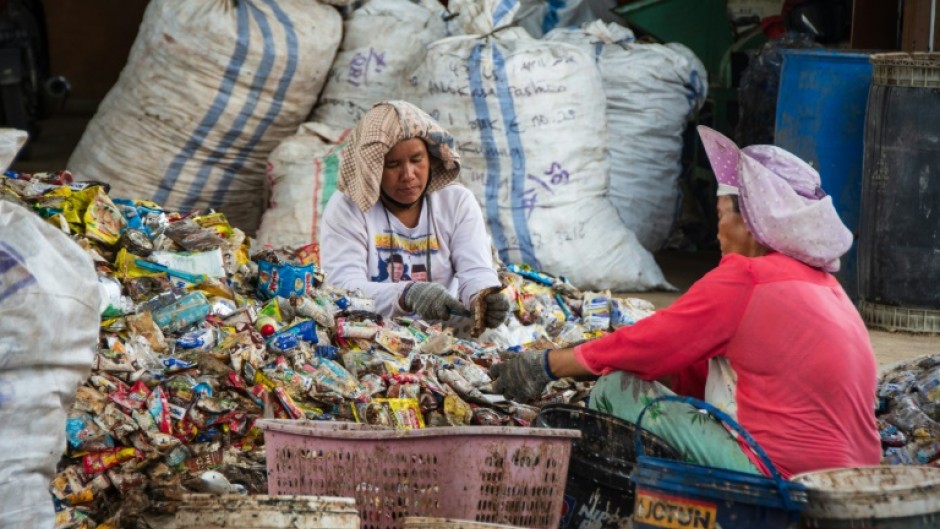 Women sorting through plastic waste in Pekanbaru, Indonesia