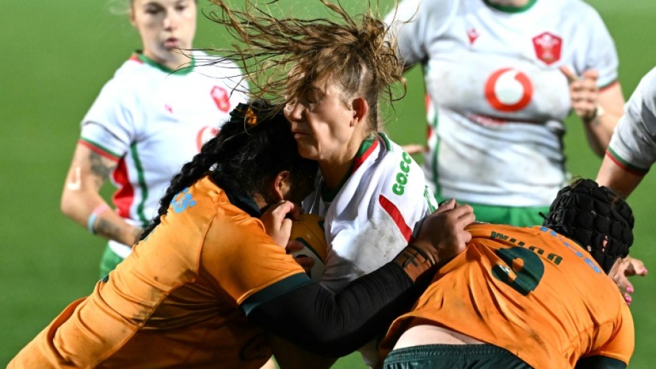 Taking guard: Australia’s Faliki Pohiva (L) and Samantha Wood tackle Carys Cox (C) of Wales in a Test in Sydney on August 1. At the World Cup, the players will wear high-tech gum shields