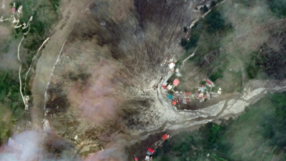 This satellite image from Maxar Technologies shows the destruction from the flood and landslides in Dharali