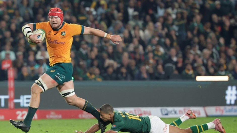 Australia's Harry Wilson (L) skips out of Manie Libbok's tackle to score in Johannesburg