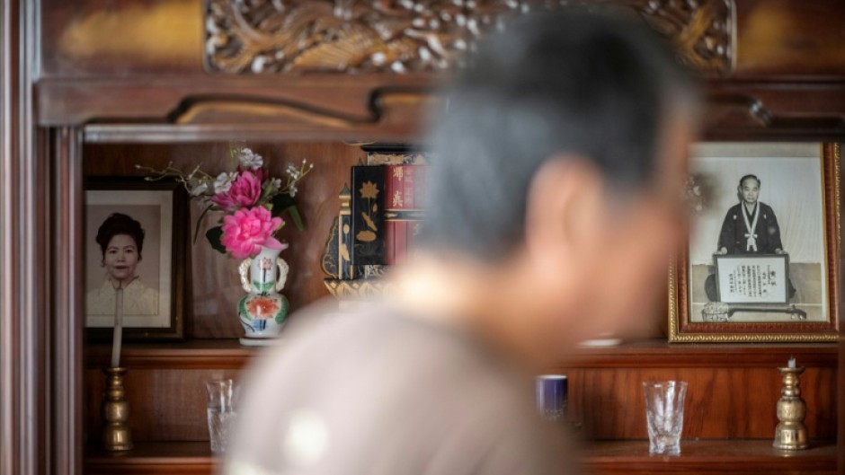 A portrait (L) of Takemasa Kinjo's mother, who was killed by a US Marine in 1974