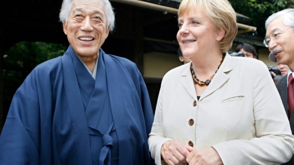 Sen Genshitsu, pictured in 2007 meeting Germany's then chancellor Angela Merkel, stressed the calming effects of tea culture