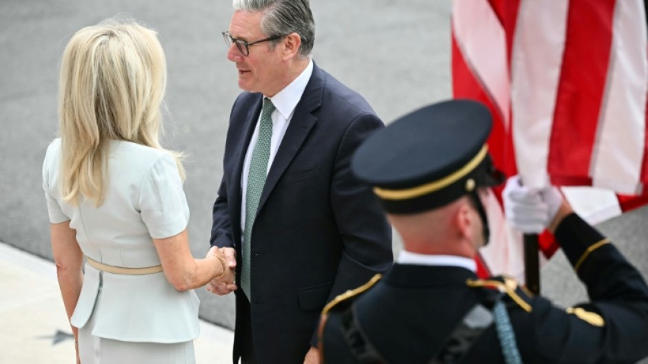 British Prime Minister Keir Starmer is greeted by US Chief of Protocol Monica Crowley (L) upon arrival at the White House South Portico in Washington, DC, on August 18, 2025