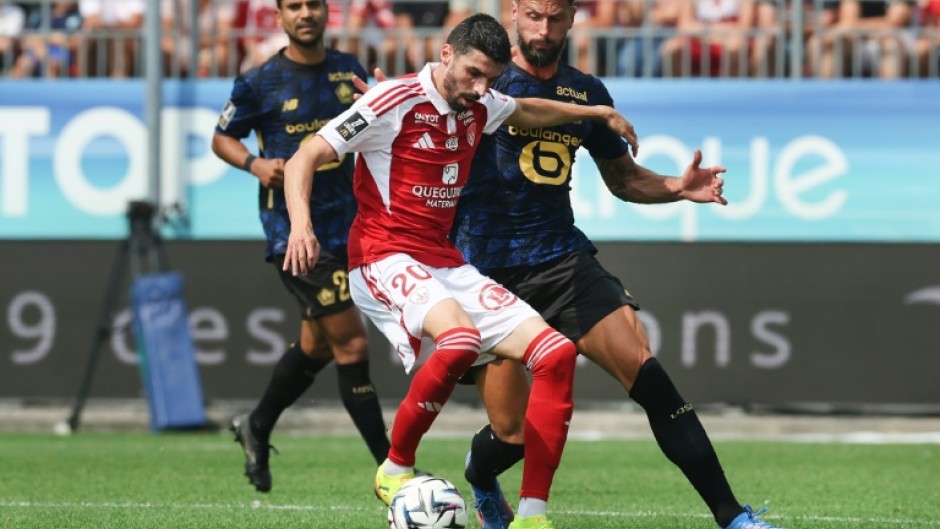 Olivier Giroud (R) scored for Lille in their draw with Brest on his return to Ligue 1 after 13 years away