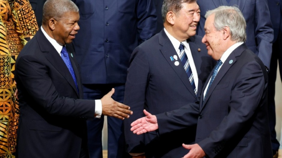 Angolan President Joao Lourenco (L) greets UN Secretary-General Antonio Guterres (R) during the 9th Tokyo International Conference on African Development in Japan