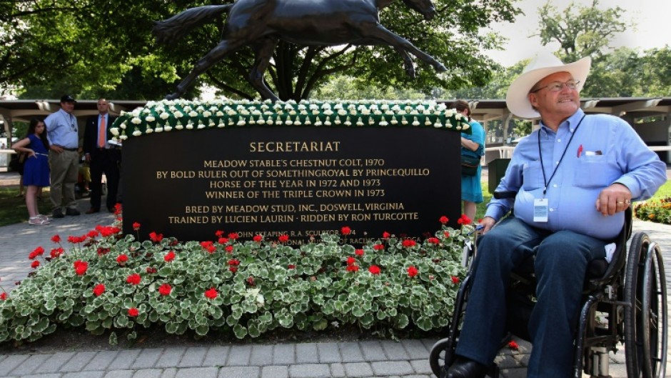 Ron Turcotte, jockey of 1973 Triple Crown winner Secretariat, poses for photos at Belmont Park in 2012