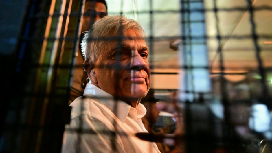 Sri Lanka's former president Ranil Wickremesinghe looks on as he sits in a prison bus in Colombo