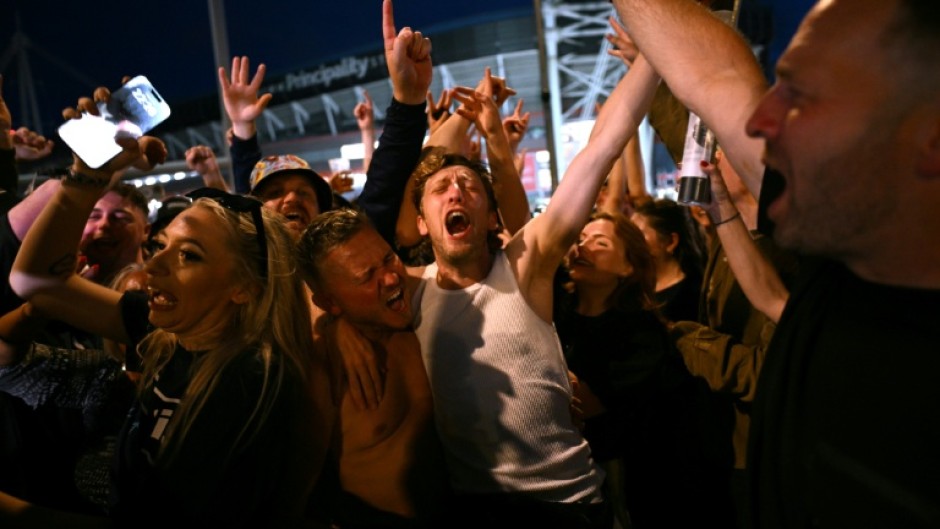 Oasis fans rock out last month during the band's first tour in 16 years in Cardiff, Wales