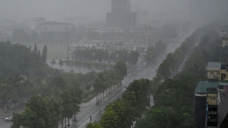 Rain falls above the buildings and a street in Vinh city on August 25, 2025, before Typhoon Kajiki makes landfall in Vietnam