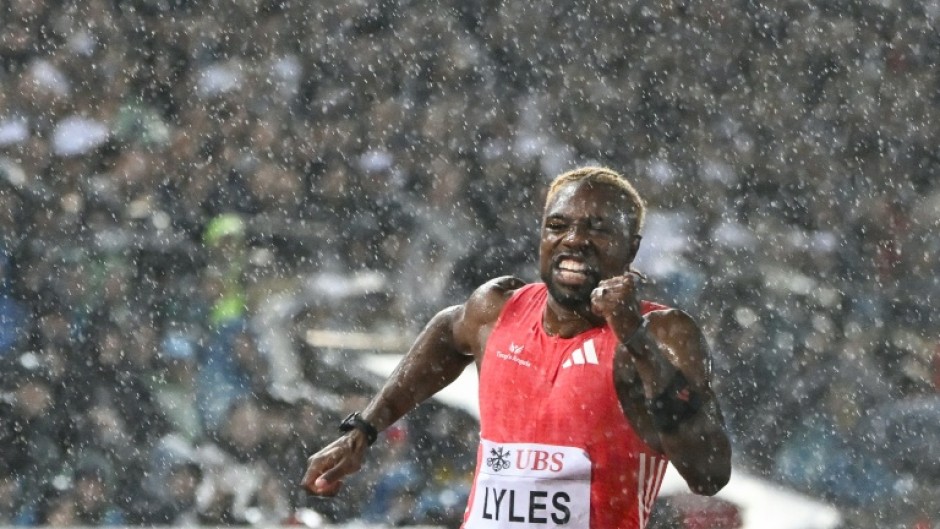 US sprinter Noah Lyles runs under the rain as he competes in the 100m event at the Lausanne Diamond League meet