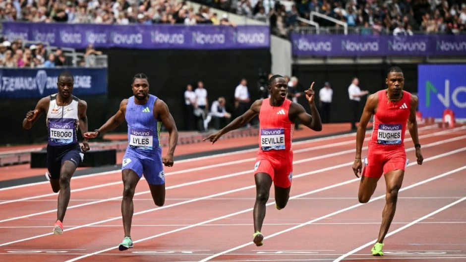 Jamaica's Oblique Seville (2nd R), celebrates as he denies Noah Lyles (2nd L), at the London Diamond League