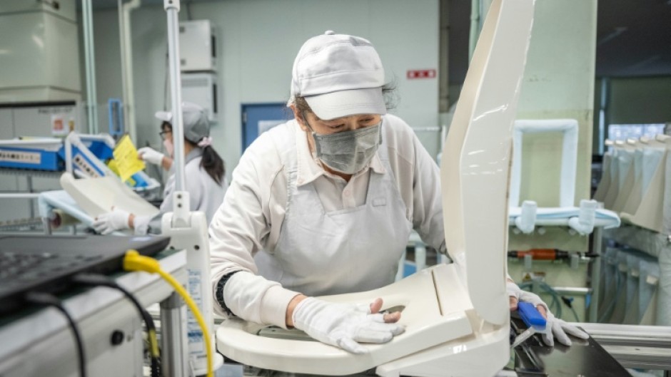 A worker at an assembly line of the Washlet Techno factory of Japanese toilet manufacturer TOTO in To