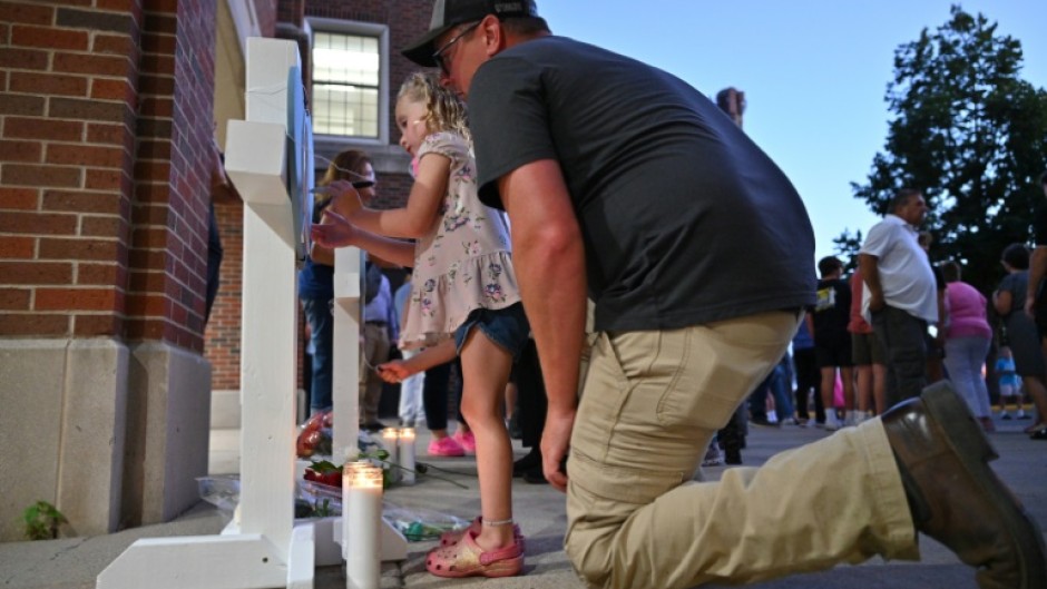 A vigil was held in Minneapolis for a church shooting in which two children were killed and 18 other people were injured