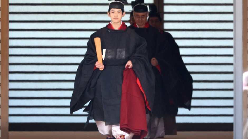 Japanese Prince Hisahito wearing an ancient ceremonial costume, leaves for a ceremony by a carriage at the Imperial Palace in Tokyo