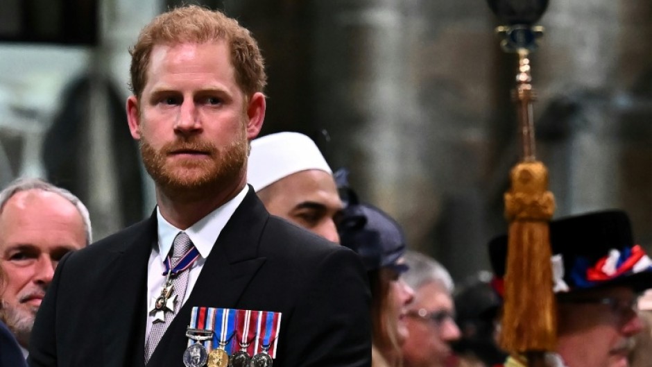 Britain's Prince Harry, the Duke of Sussex, looks on as his father leaves Westminster Abbey after being crowned King Charles III in 2023
