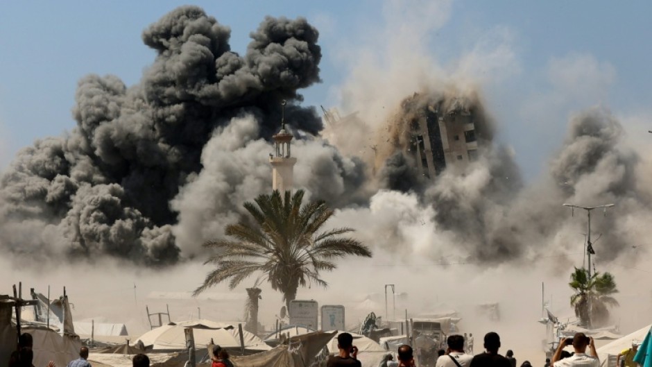 Smoke billows from Israeli strikes that brought down a high-rise tower in Gaza City on Friday