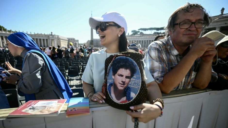 A faithful holds a portrait of Carlo Acutis during a Jubilee audience at the St Peter's Square on Saturday