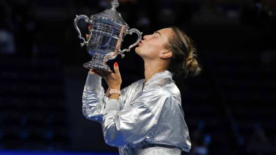 Aryna Sabalenka kisses the US Open trophy after retaining her title with a straight sets defeat of Amanda Anisimova