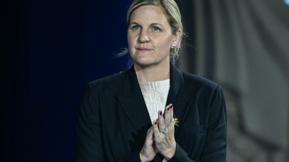 The President of the International Olympic Committee Kirsty Coventry reacts on the podium of the women's 100m backstroke swimming event during the 2025 World Aquatics Championships in Singapore