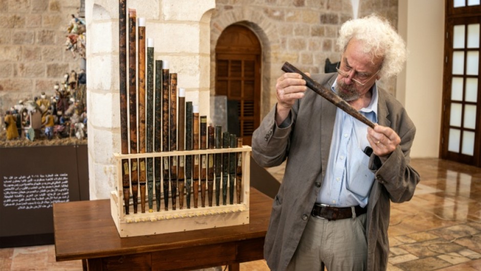 A man inspects a piece of the functioning replica from the oldest organ in Christendom, during the instrument's unveiling at the Saint Saviour's Monastery in the old city of Jerusalem