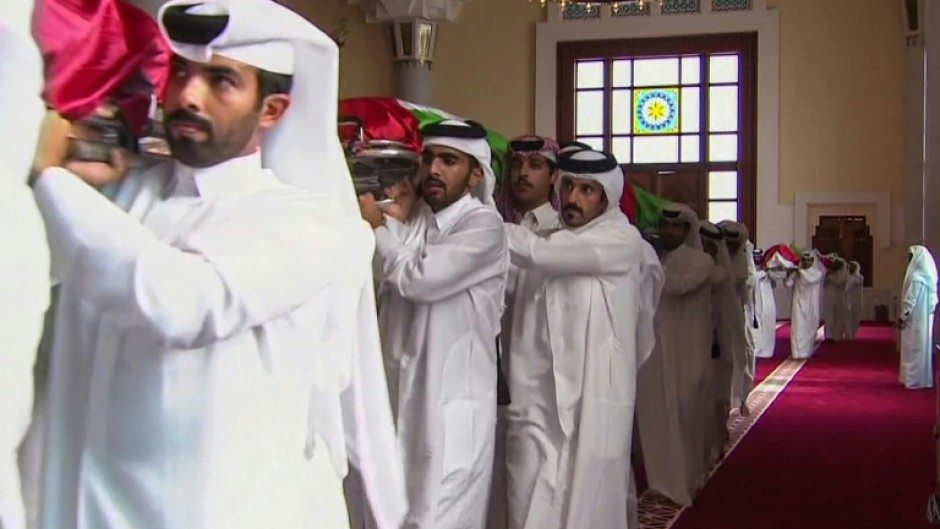 Pallbearers carry the shrouded bodies of the dead inside Doha's Sheikh Mohammed bin Abdul Wahhab Mosque in this Qatar TV image.